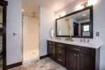 Master bath has double sinks and a walk-in shower